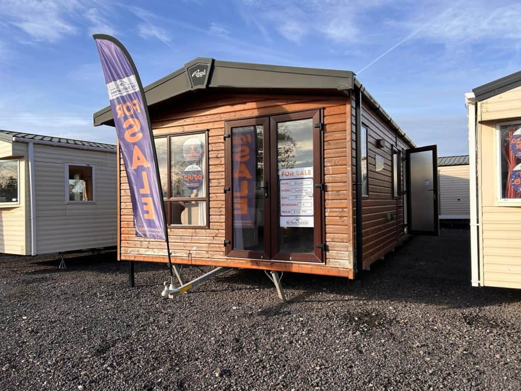 wooden clad static caravan, lodge with double doors.