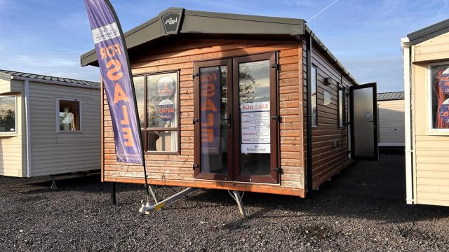 wooden clad static caravan, lodge with double doors.