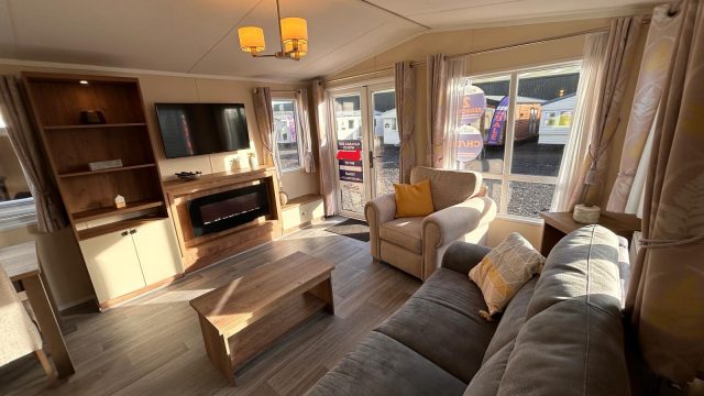 grey sofa, coffee table, tv on wall, built in shelving