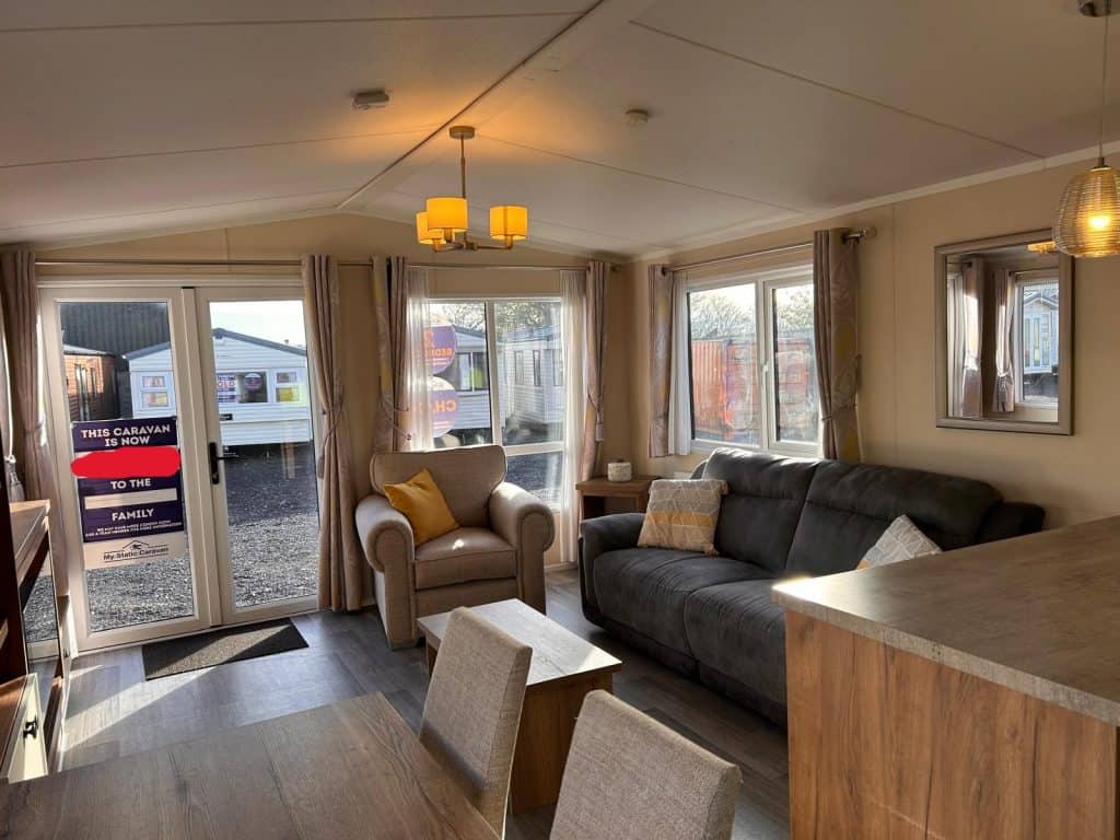 grey sofa with armchair. double doors and window