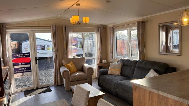 grey sofa with armchair. double doors and window