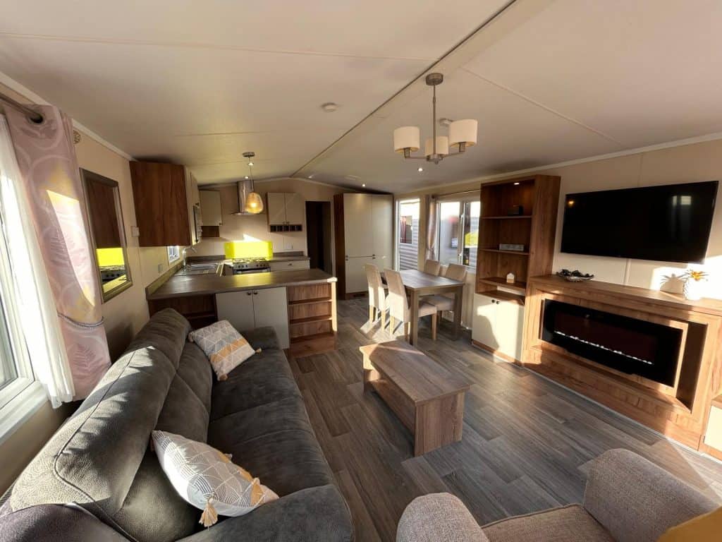 living room with sofa with view into kitchen area