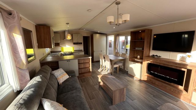 living room with sofa with view into kitchen area