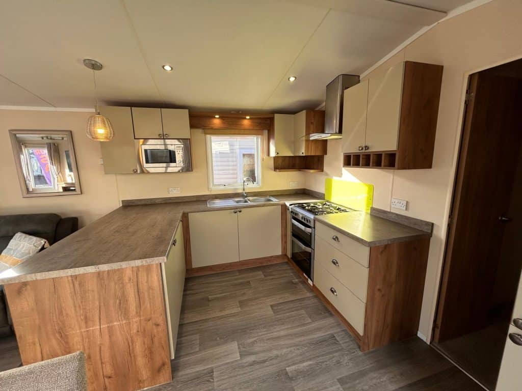 cream fitted kitchen in a static caravan, built in microwave