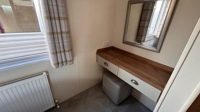 dressing table with mirror on wall. radiator on wall