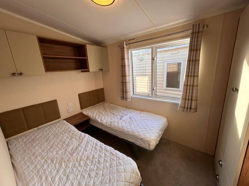 2 single beds in room with wardrobe
