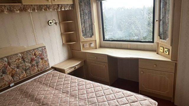 Double bed in static caravan with dressing table