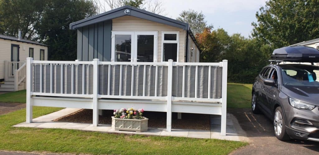 Front view of Swift Static Caravan with white fence