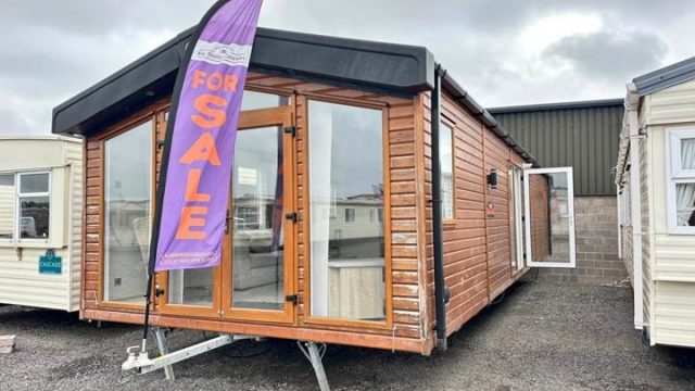 Wooden clad static caravan with patio doors