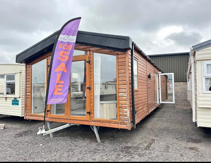 Wooden clad static caravan with patio doors