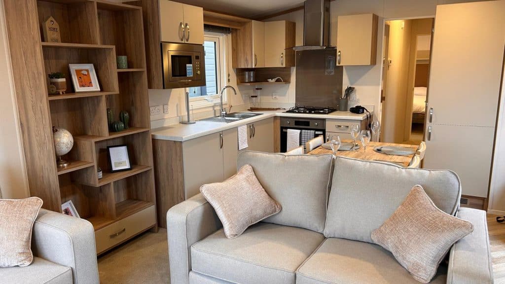 2 seater sofa with bookcase looking into kitchen