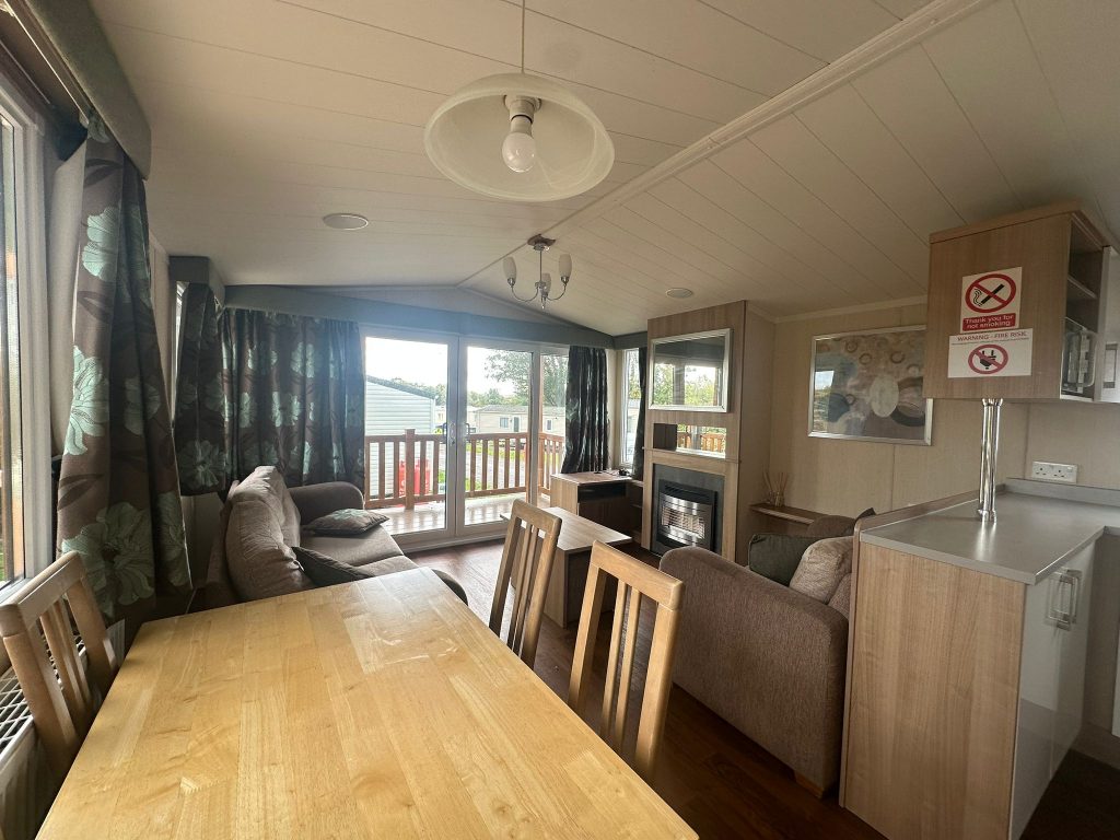 Dining table 2 chairs view into lounge area