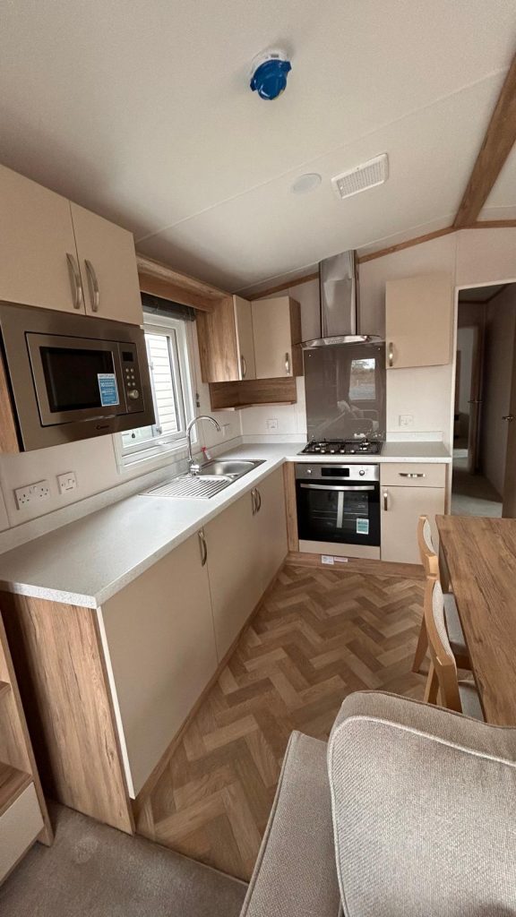 Kitchen with mircowave built in and gas cooker, herribone flooring