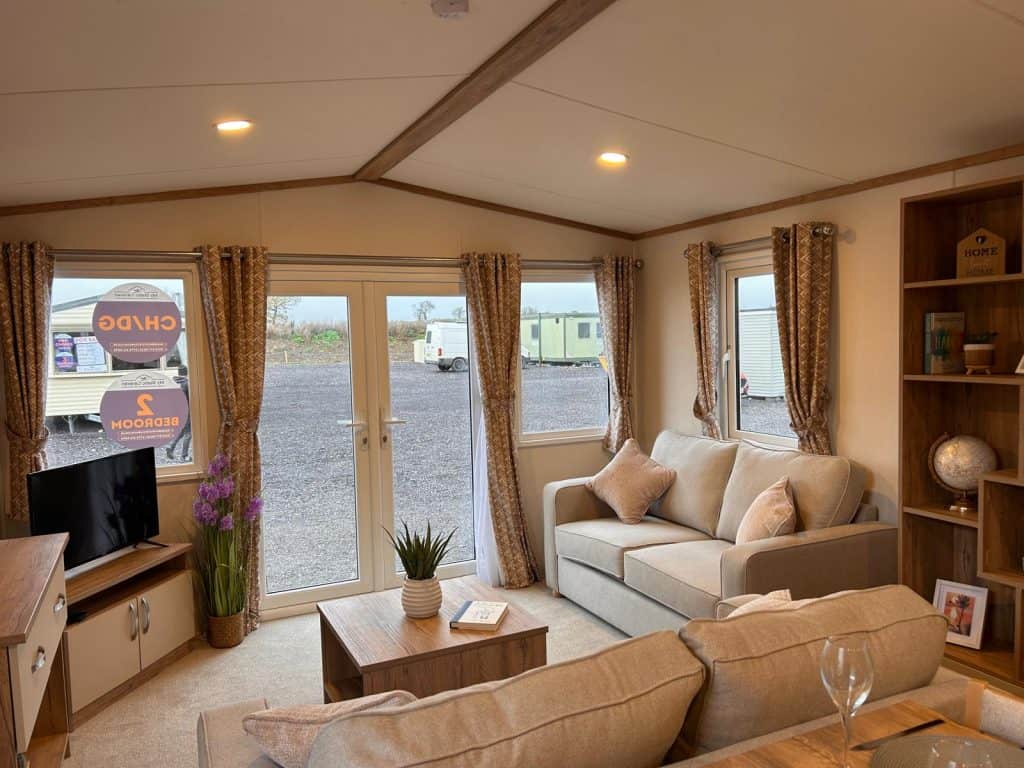 2 seater sofa with cushions. kitchen with cupboards