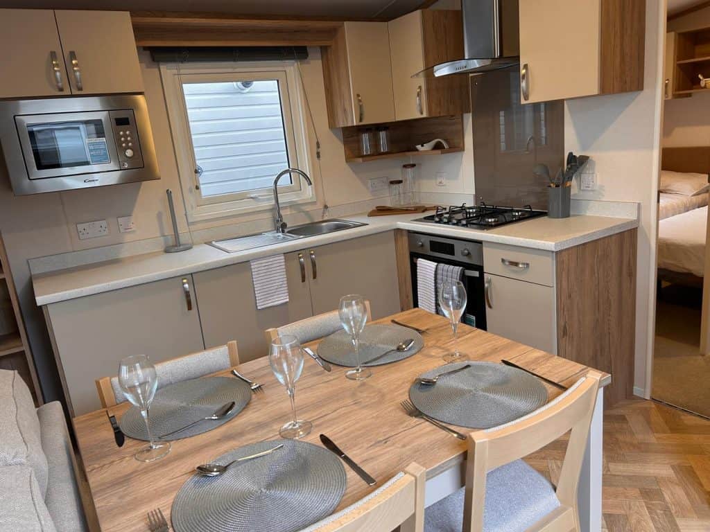 4 seater dining table and chairs with place mats and glasses