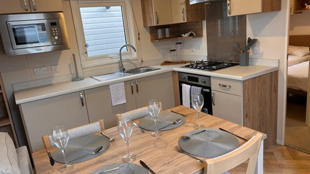 4 seater dining table and chairs with place mats and glasses