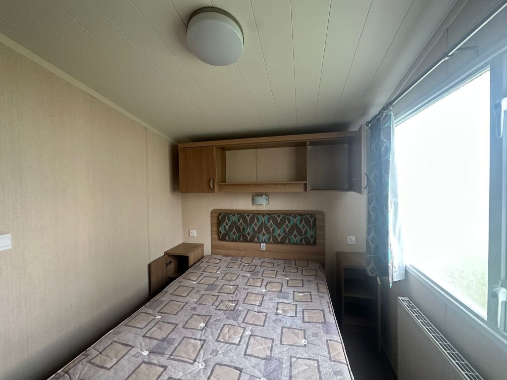 double bed with shelving above bed