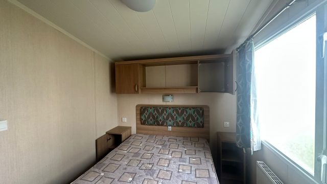 double bed with shelving above bed