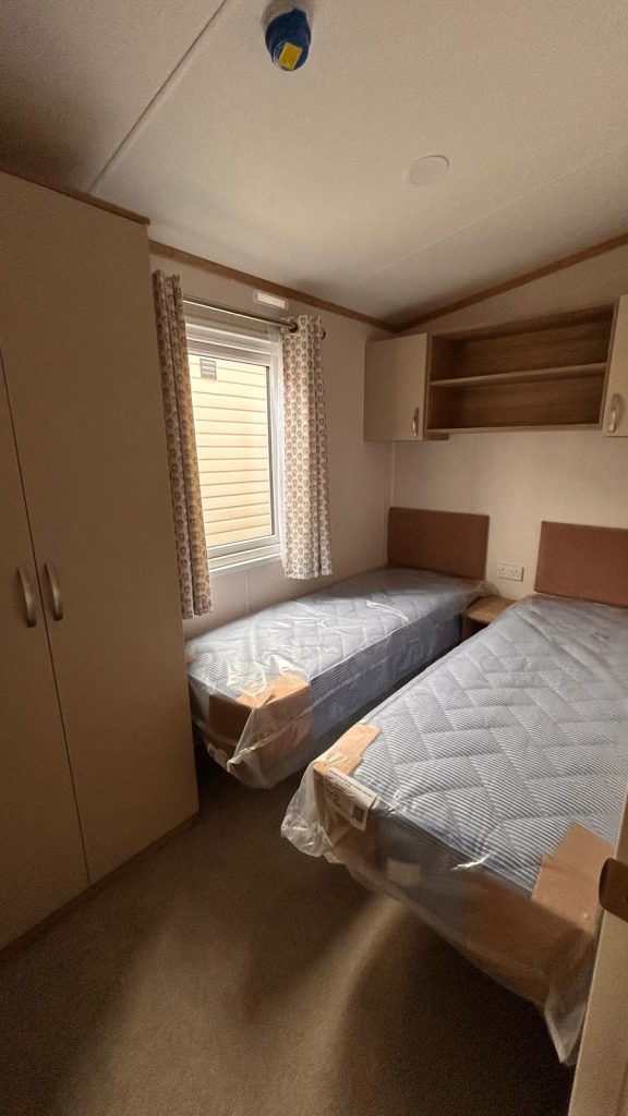 2 single beds in a room with wardrobe