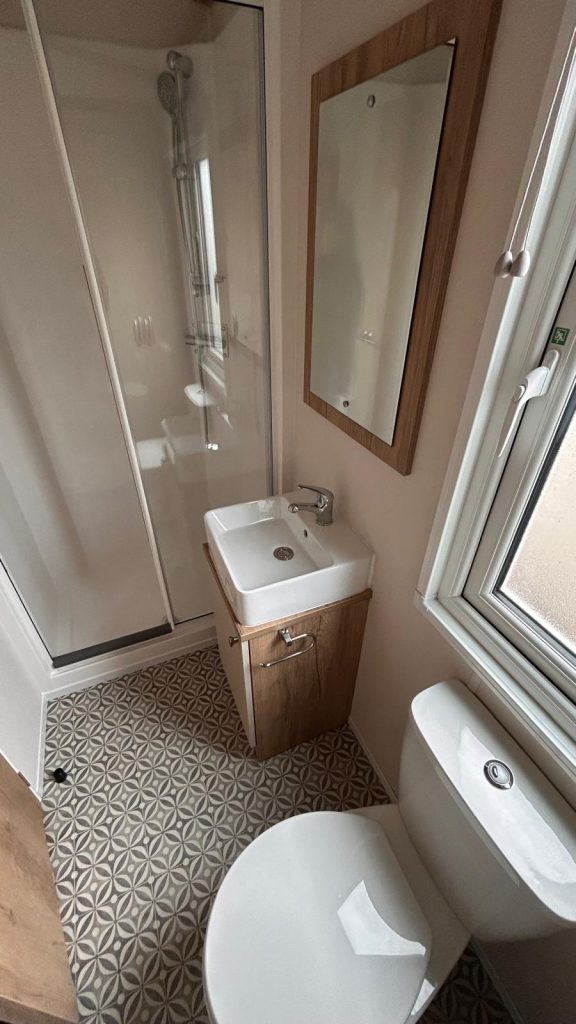white square sink with shower cubicle