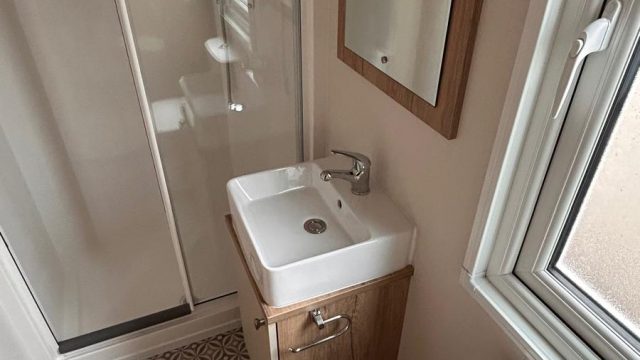 white square sink with shower cubicle