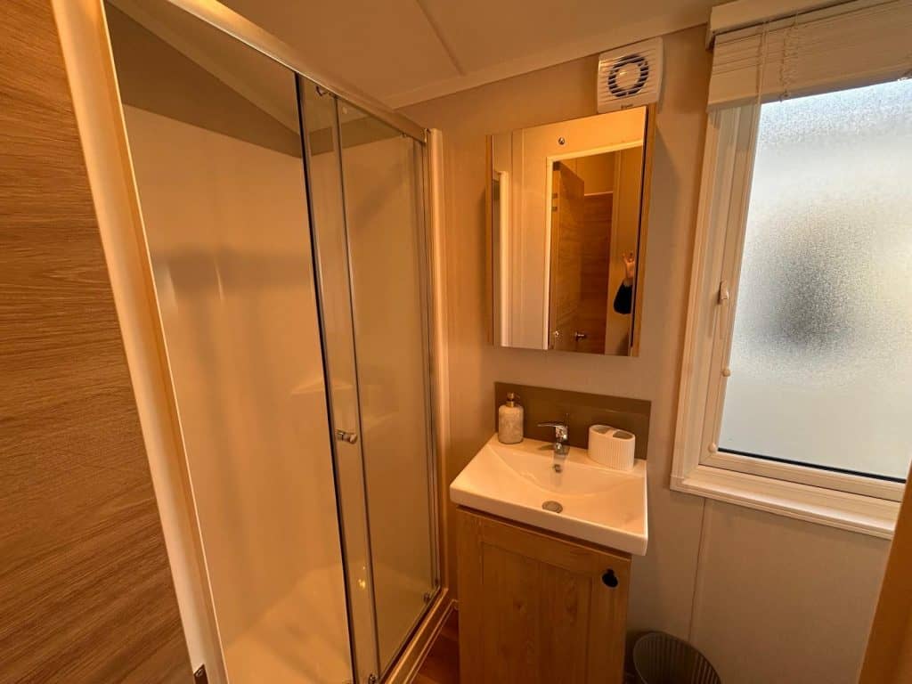 large shower cubicle with vanity basin and mirror