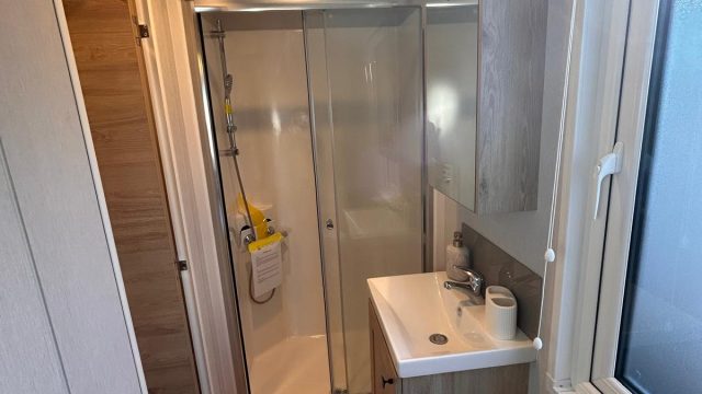 large grey sofa with 2 arm chairs and coffee table