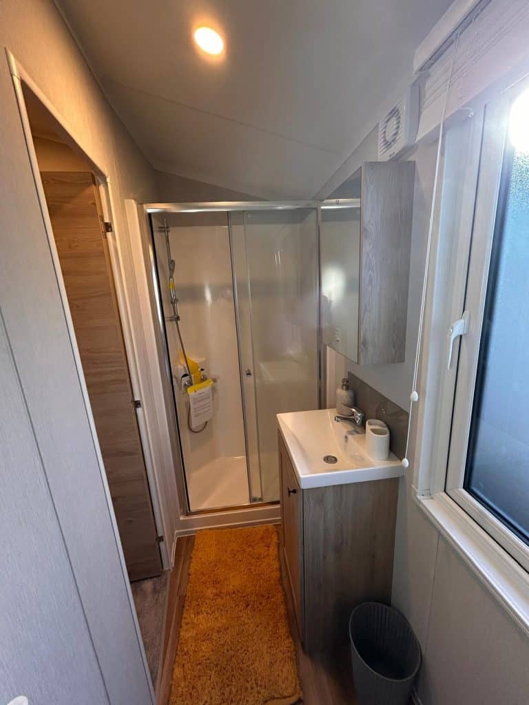 large grey sofa with 2 arm chairs and coffee table