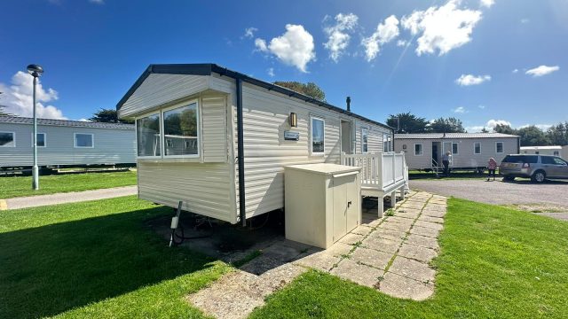 cream static caravan with storage box and steps