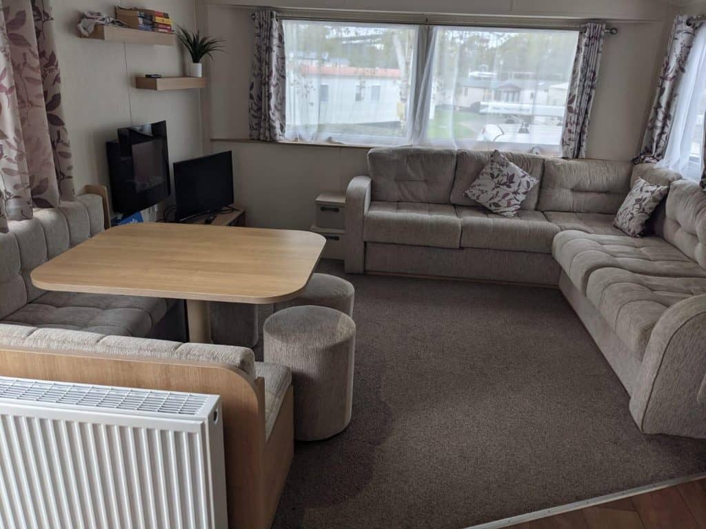 Corner sofa, dining table and stools TV in corner