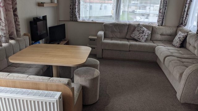 Corner sofa, dining table and stools TV in corner