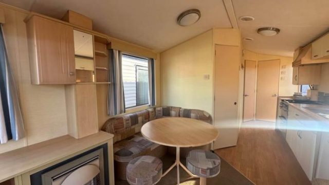 gas fire in lounge with round dining table and 2 stools