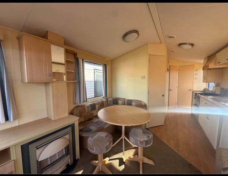 gas fire in lounge with round dining table and 2 stools