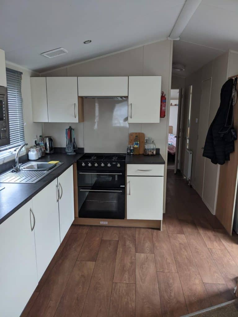 white kitchen cabinets with a black gas cooker