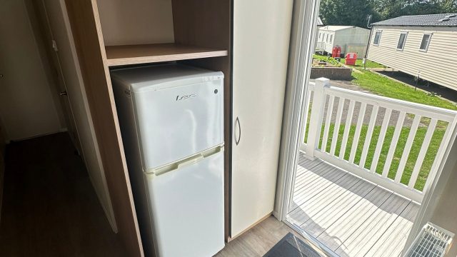 open door to static caravan. fridge freezer
