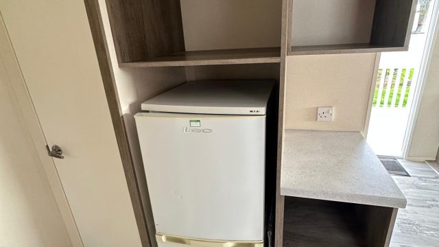 fridge freezer in cupboard.