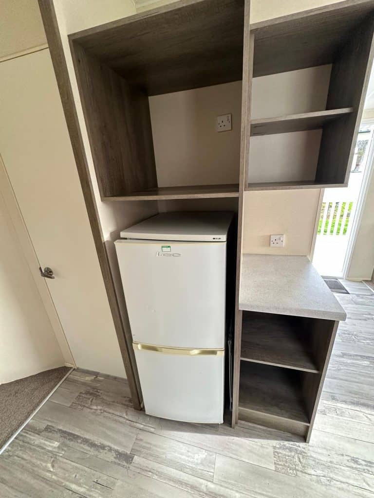 fridge freezer in cupboard.