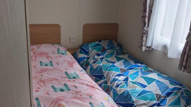 two twin beds with side window