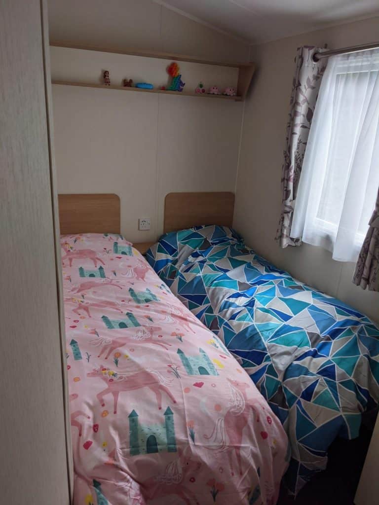 two twin beds with side window