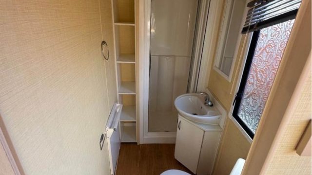 shower cubicle with sink and toilet.