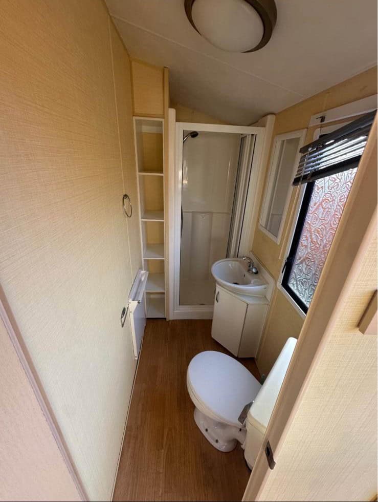 shower cubicle with sink and toilet.