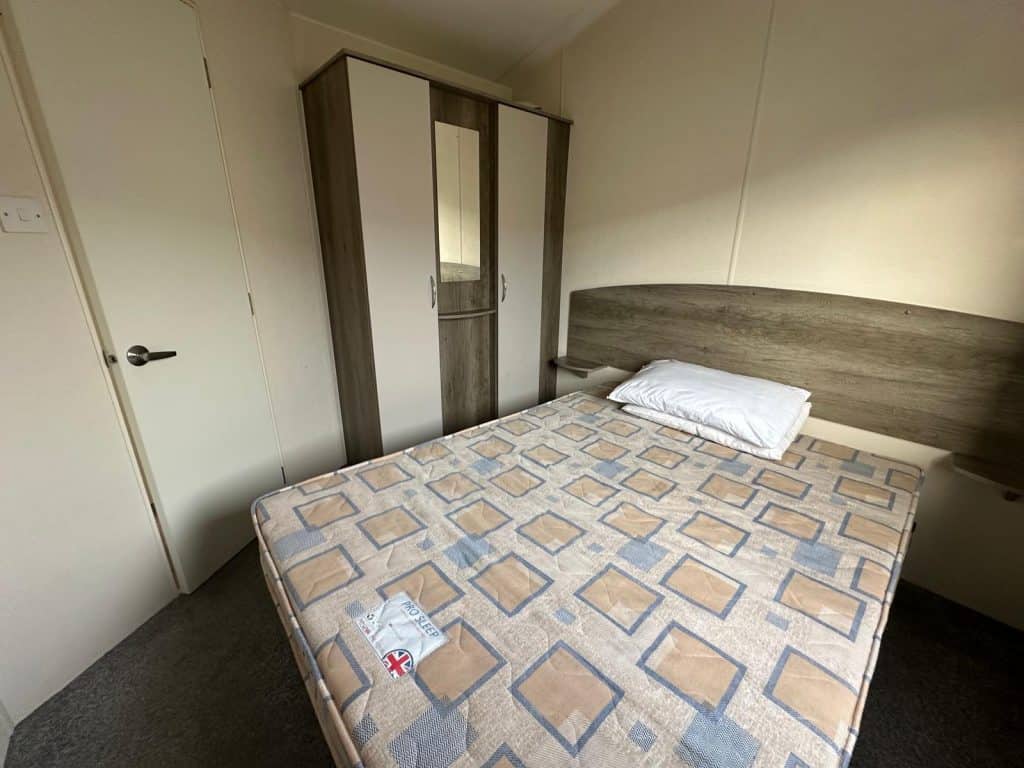 double bed with wardrobes next to it