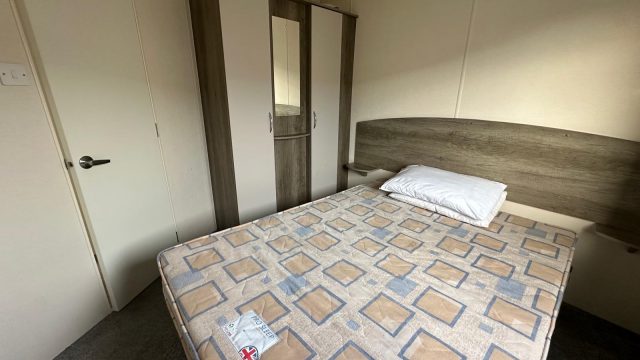 double bed with wardrobes next to it