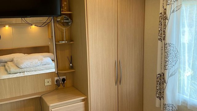 double wardrobe with chest draws. TV on wall