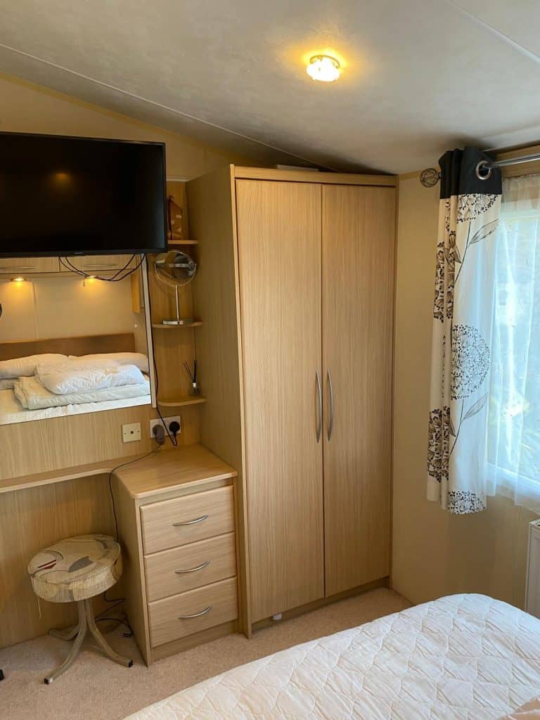 double wardrobe with chest draws. TV on wall