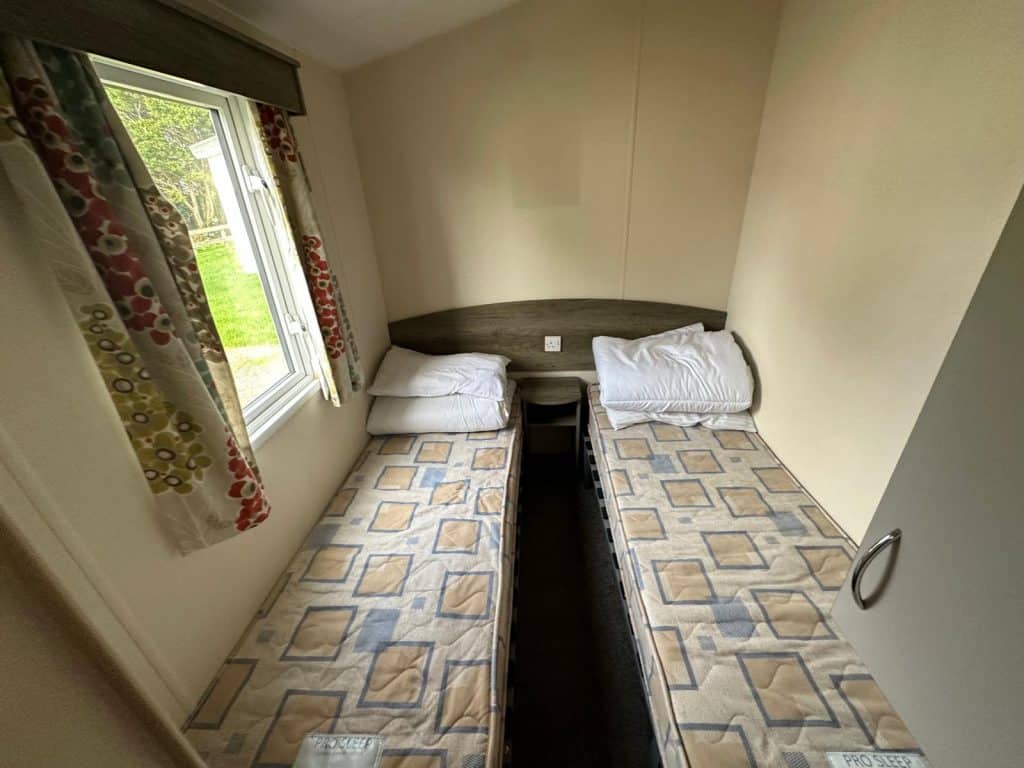 2 single beds with mattress and side window