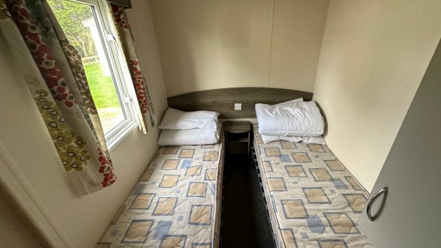 2 single beds with mattress and side window
