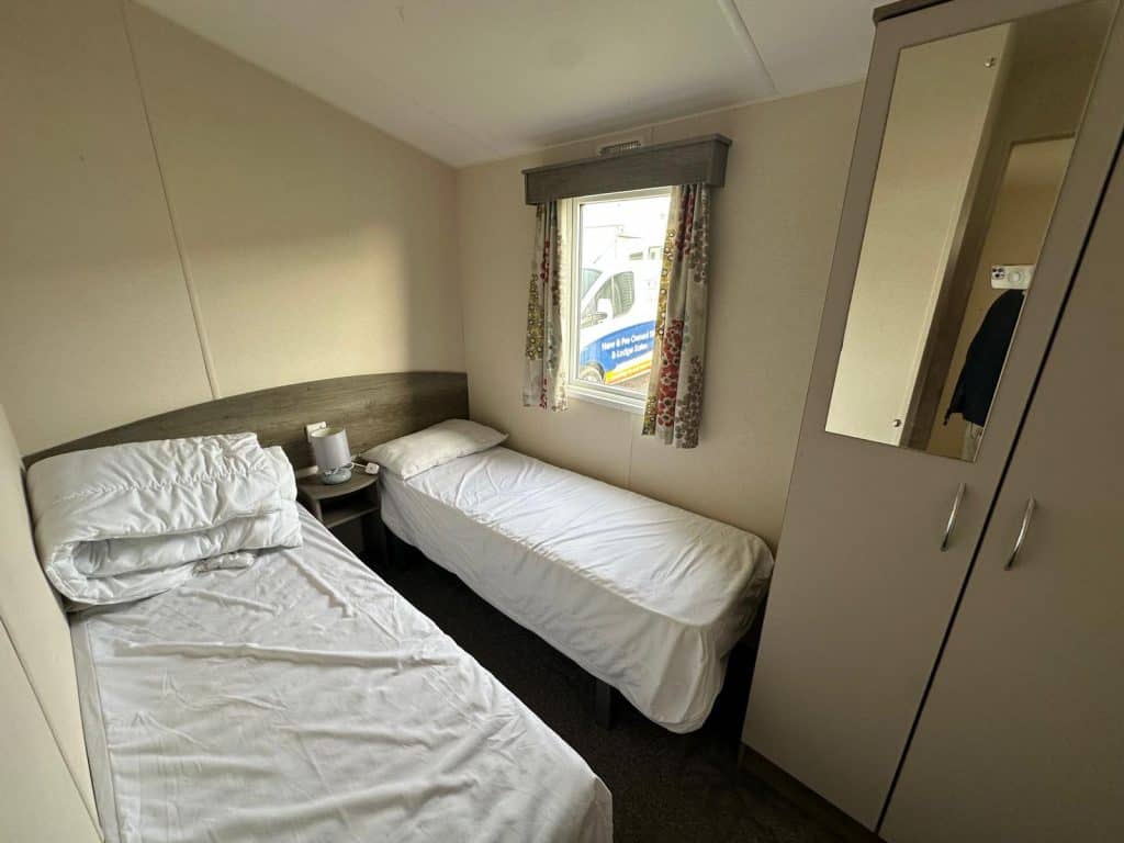 2 single beds with mattress and wardrobe