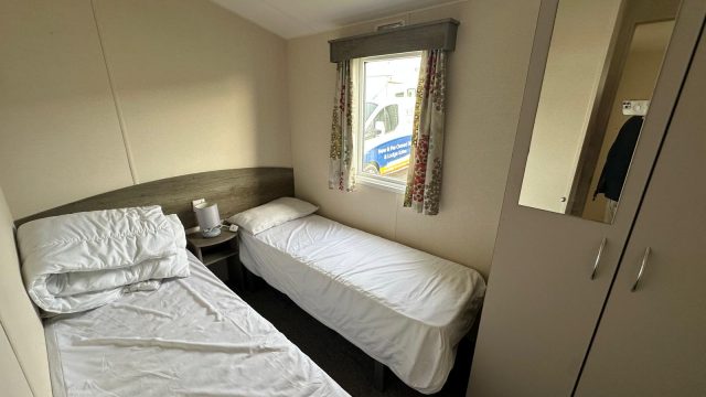 2 single beds with mattress and wardrobe