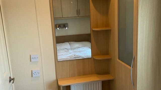 Single wardrobe by shelves with mirror and central heating